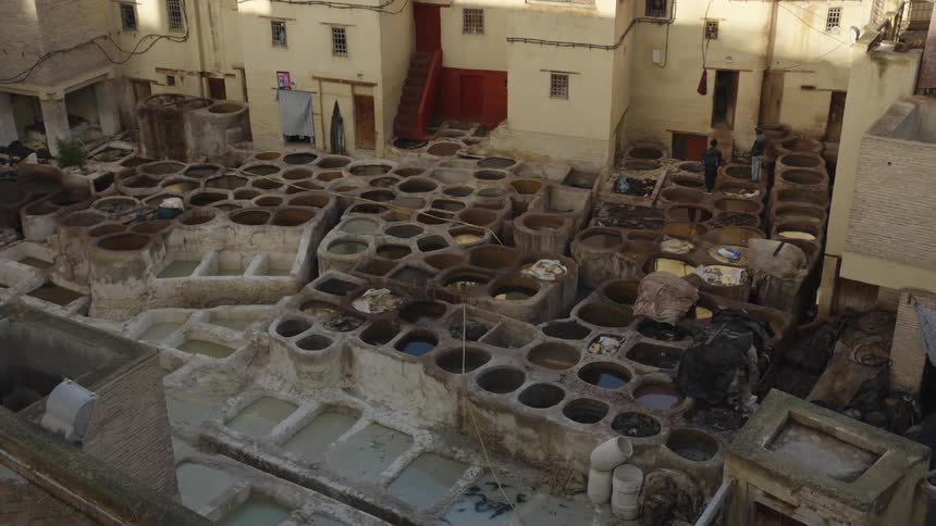 Aerial view of a traditional openair dyehouse with dozens of circular tanks