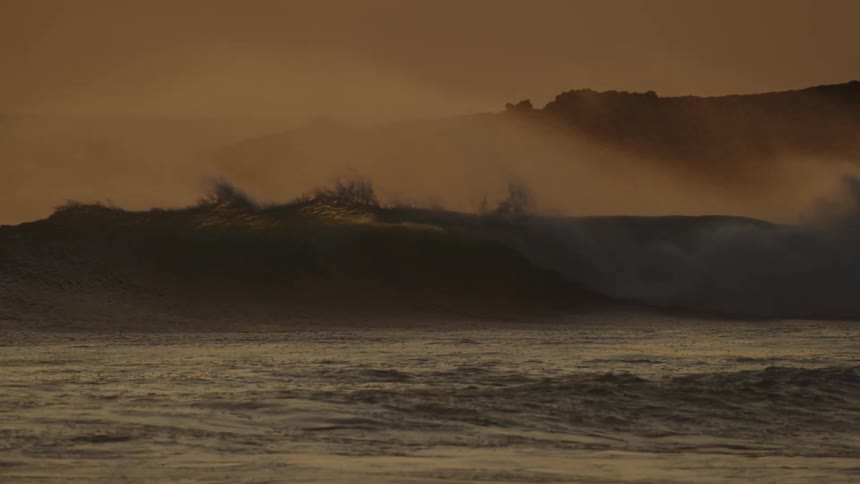Ocean waves are moving fast on a windy evening
