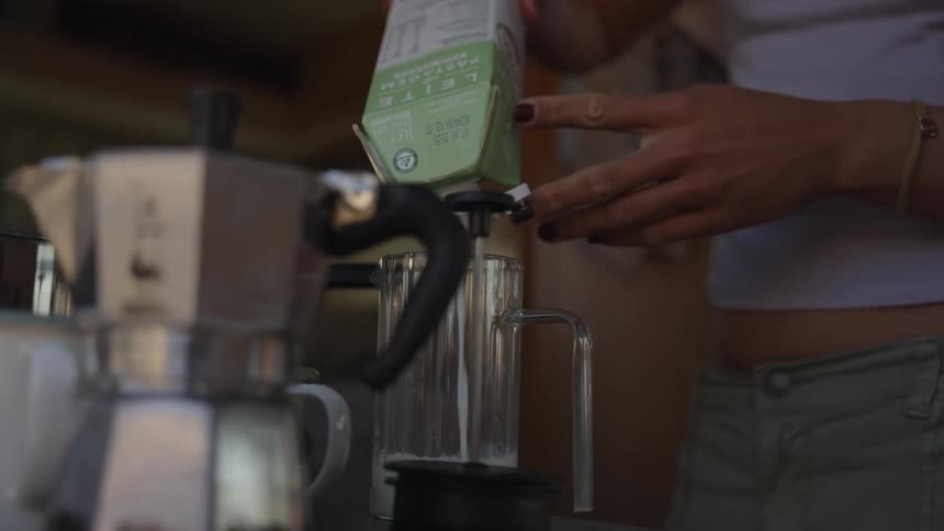 Woman pouring milk into a glass