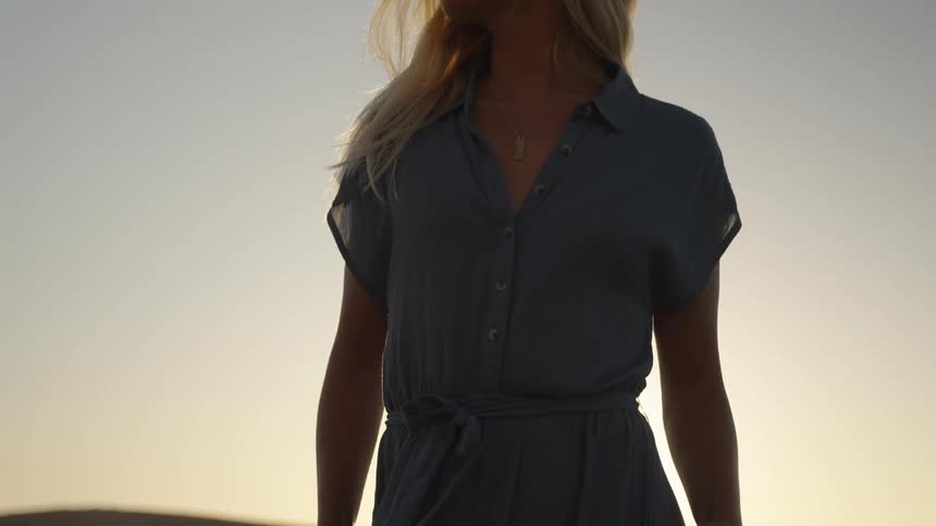 A footage of a lady standing in the desert