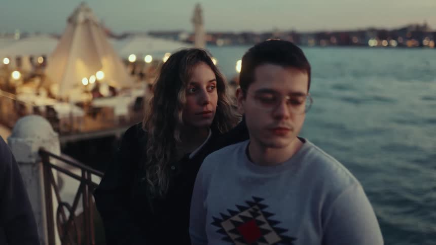 Woman and a man enjoying the view by the sea