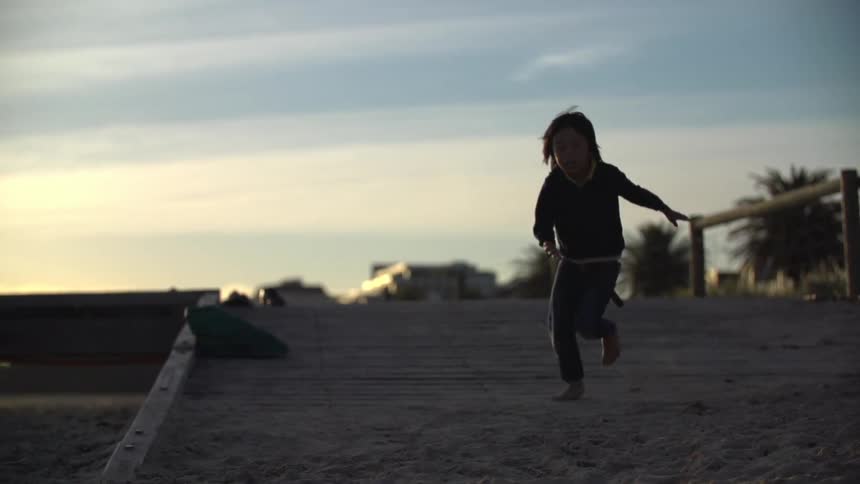 A kid running outside on a sunny day