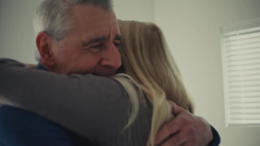 Elderly couple hugging