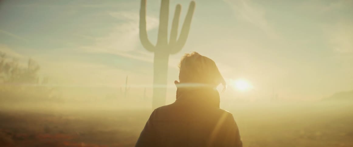 A woman is hiking through the foggy desert