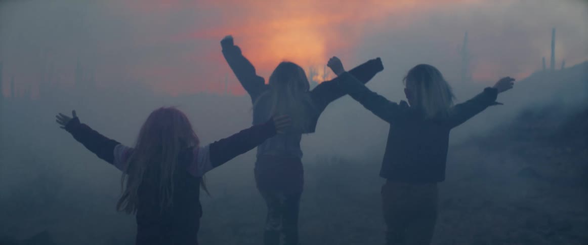 Three children with arms open surrounded by smoke asking for help