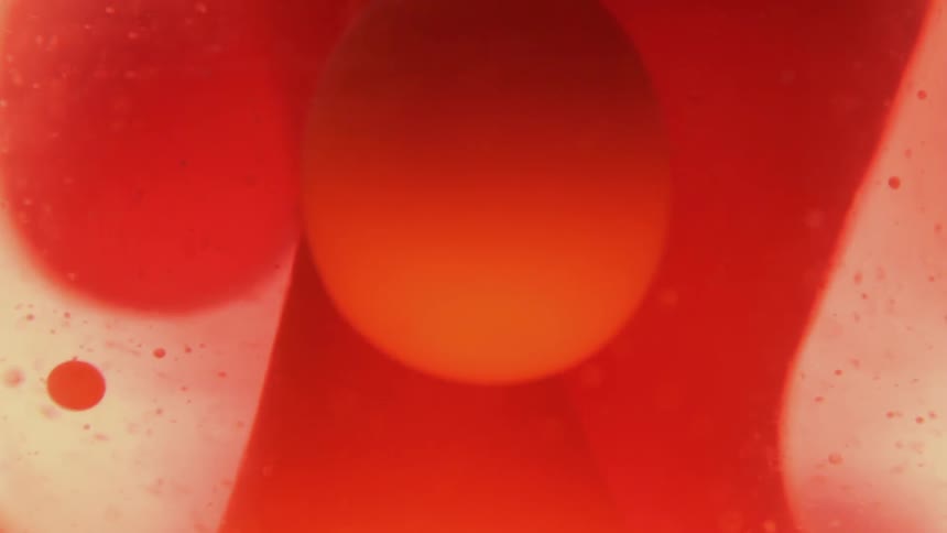 Red liquid bubbles and flows through clear liquid