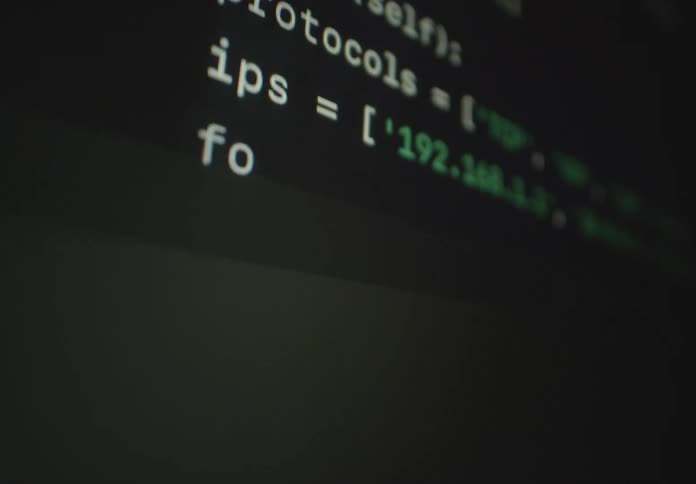 Computer code scrolls on the screen