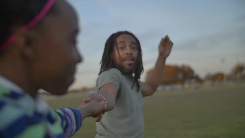 A man dances with a young child