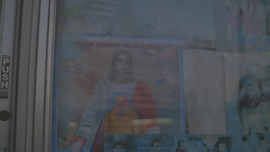 A poster of jesus hangs in a shop window