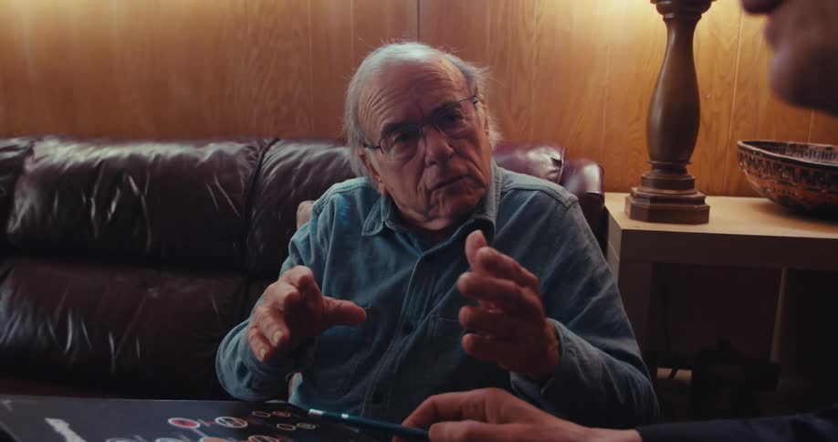 Two men are discussing a brochure