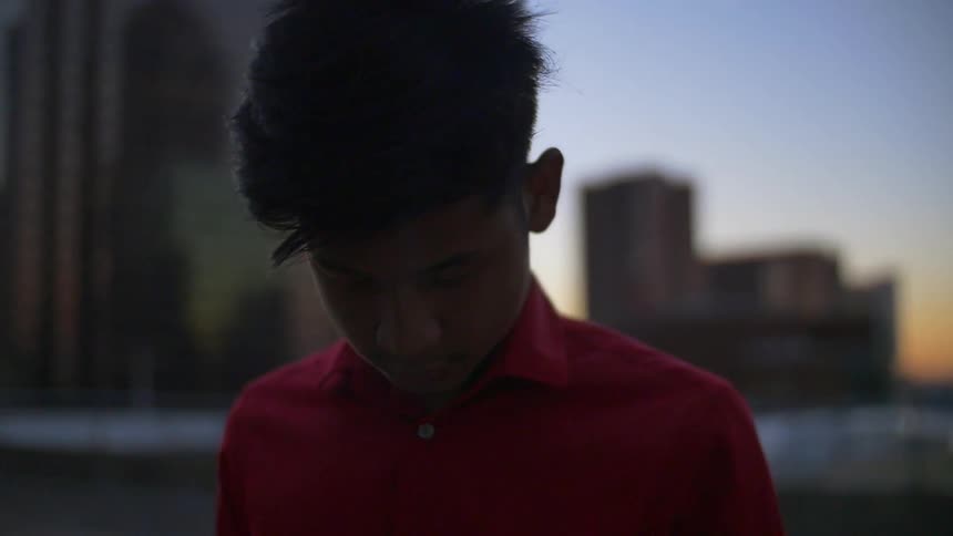 Child looking down at sunset