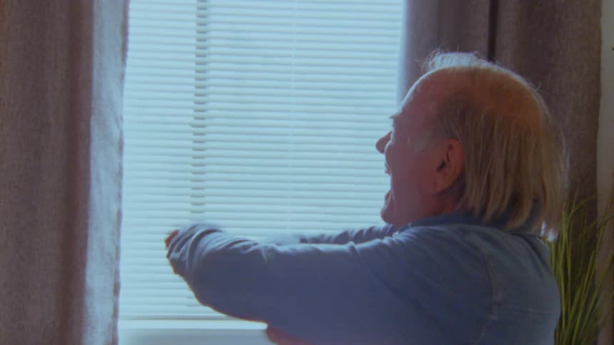 Elderly man sitting vibrating happily