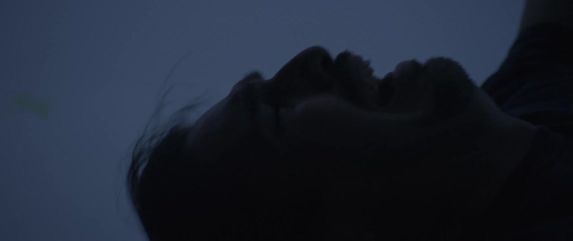 Close up of a man with hair flowing hands raised screaming as if plummeting from great heights but he is actually in a dimly lit motion capture studio