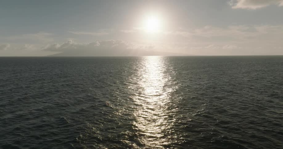 The bright sun reflects on the ocean