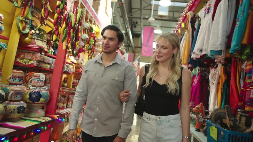 A couple point to items on the store shelves as they walk