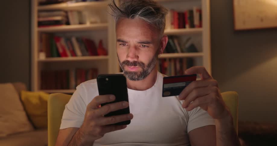 Man typing in card to phone