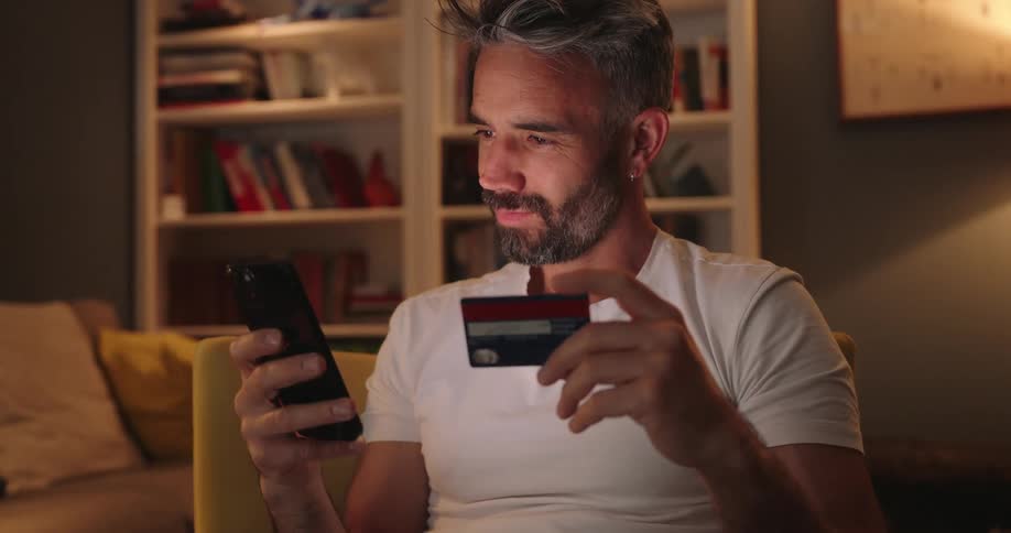 Man typing card into phone