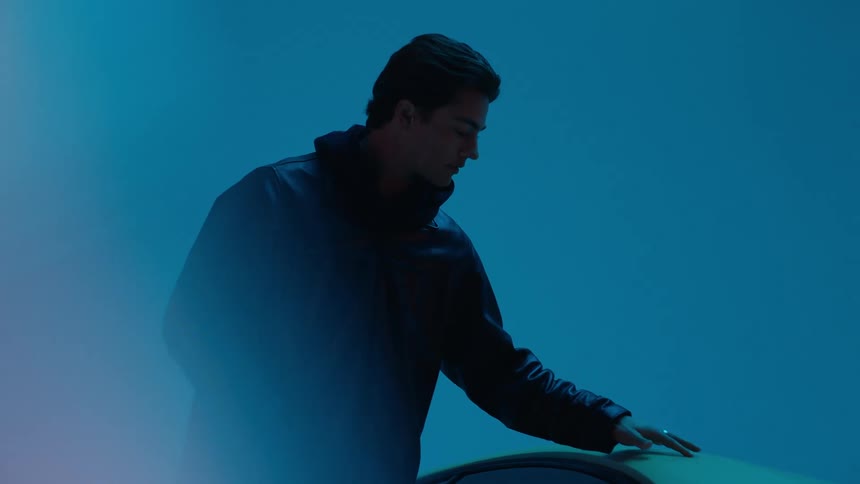 A man is looking at a car as the lights flash