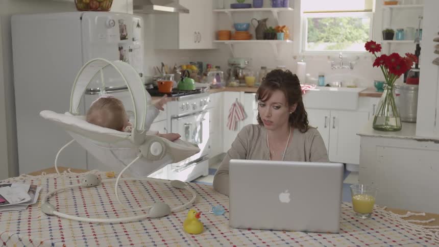A baby sitting in a rocker