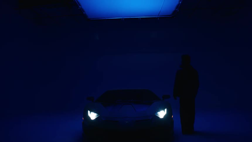Person walking up to supercar