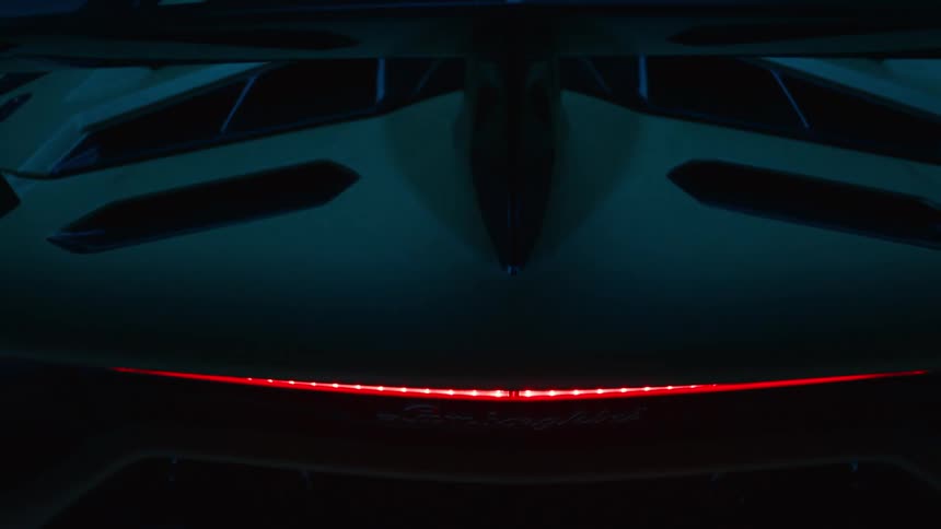 The tail lights are red on the parked sports car