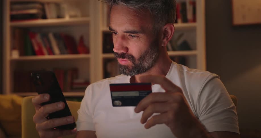 Man typing card into phone