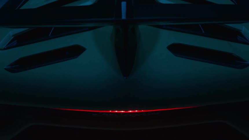 Rear view of a sports car under blinking neon lights
