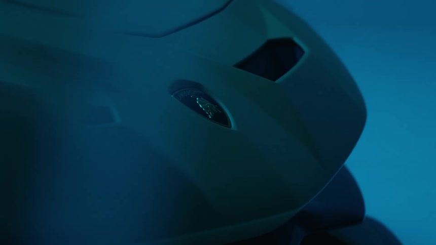White and red lights contrast with a black background and a machine matches a bit with a blue background