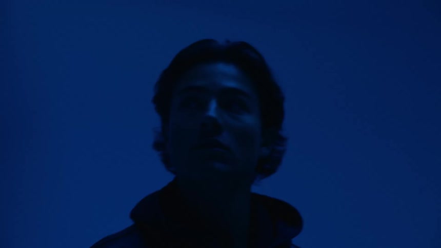 A man walks through a dark room