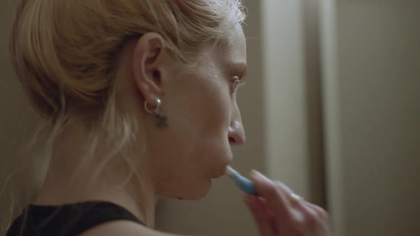 A woman is brushing her teeth