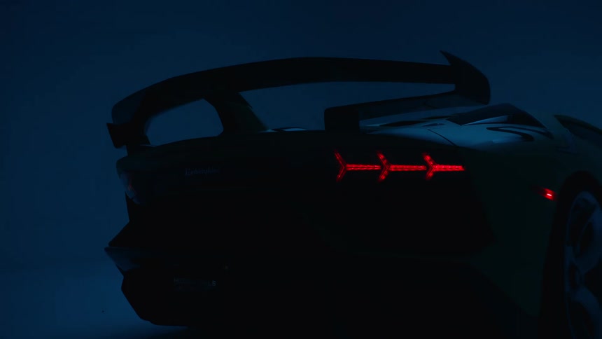 The silhouette of a sports car in a dark garage
