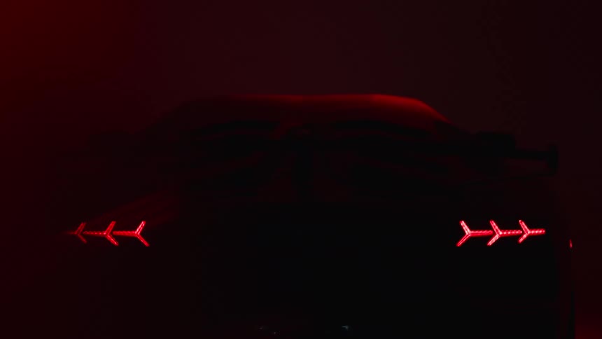 The back of a sports car with the taillights on and the surroundings fishing blue and red lights