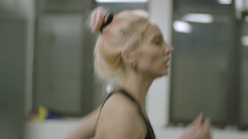 A woman runs on a treadmill