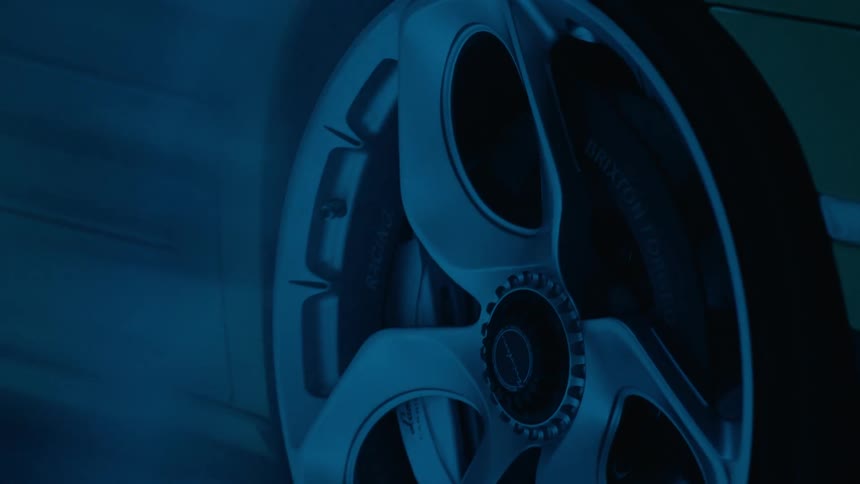 Blue light shines onto a vehicle parked indoors