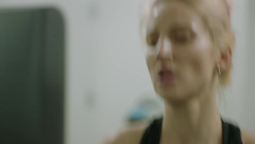 A woman is jogging on a treadmill