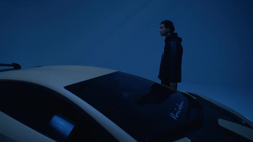 A man is looking over a sports car
