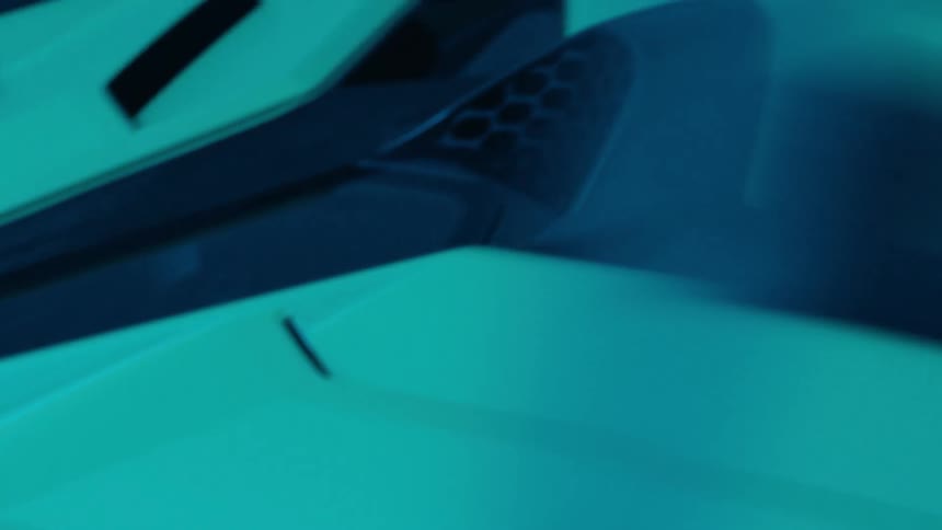 Dynamic closeup shots showcase a vehicles sleek modern bodywork under dramatic teal and blue lighting highlighting its design features