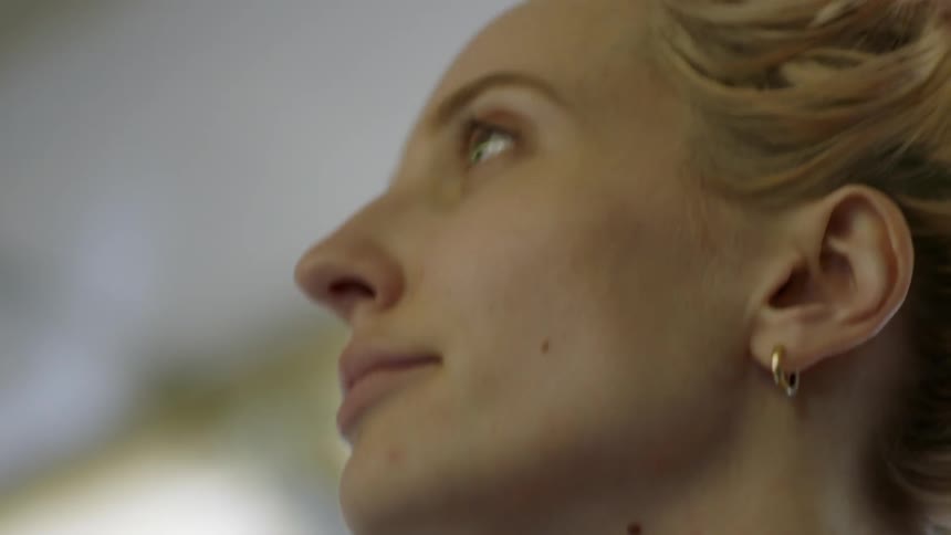 Woman bobbing head and looking over