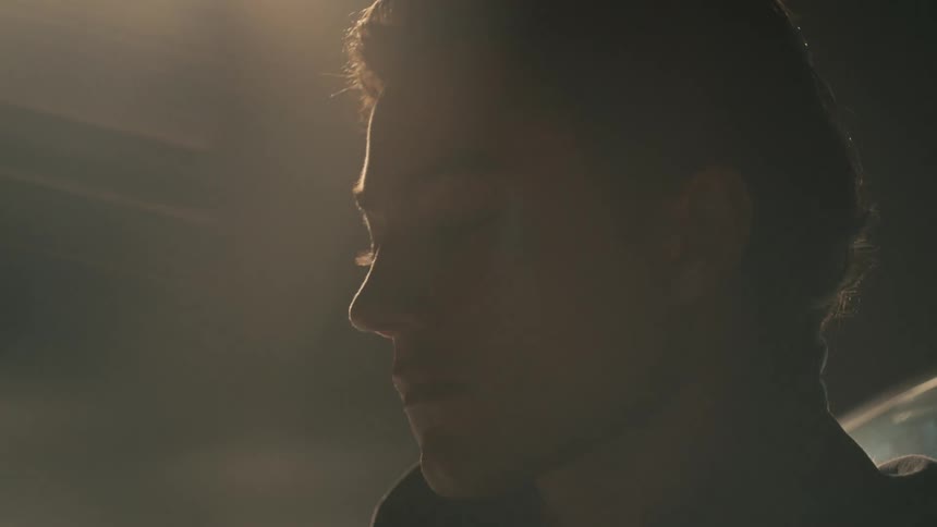 A man looks around under the flashing lights