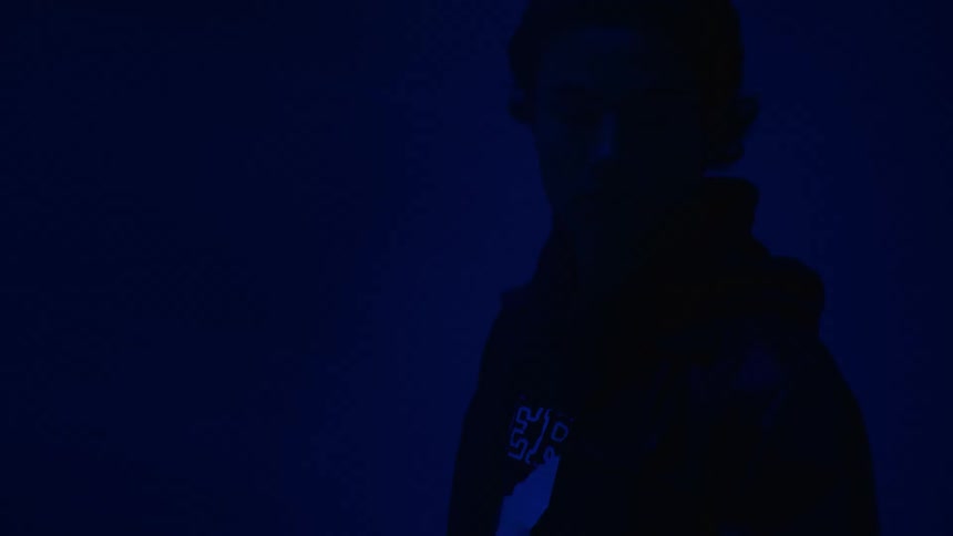 A man is standing in the dark