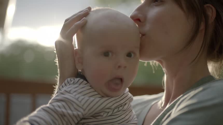 Woman kissing baby's head