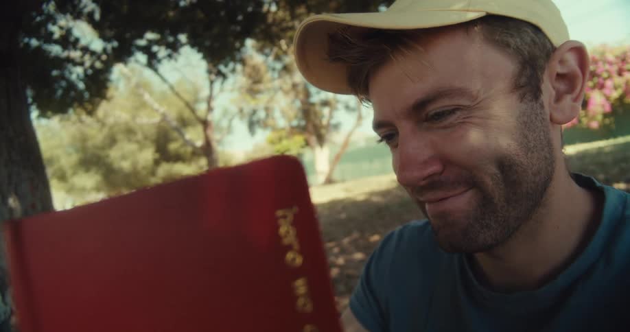 A man lays down with a book