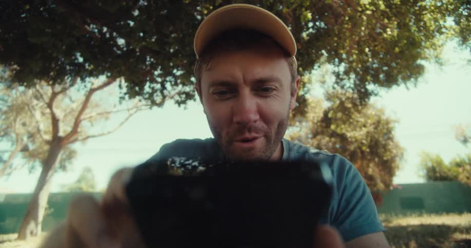 A man is typing on his cell phone