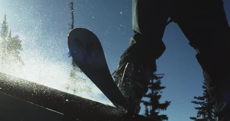 A person is riding a rail on snow skis