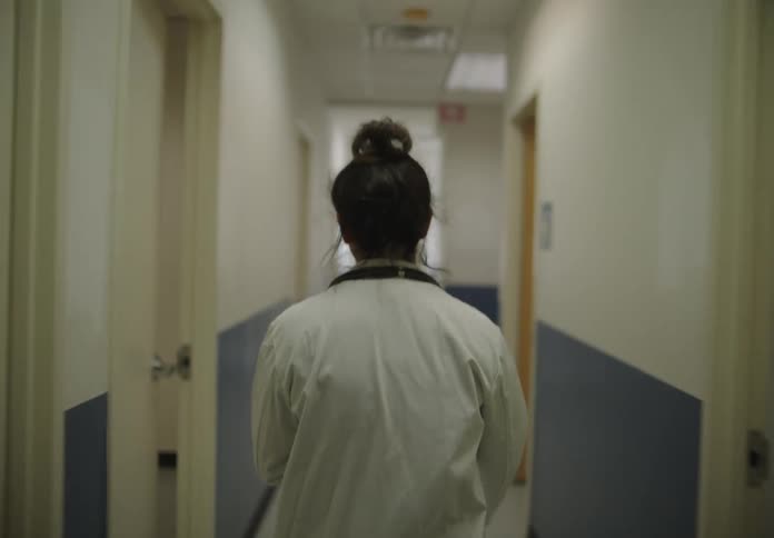 Nurse walking down a hospital corridor