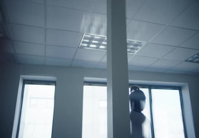 Person inside a room with windows that let in natural light