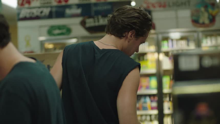 Two men in a liquor aisle of a store