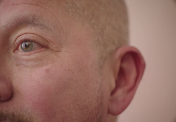 Portrait of a bald man talking
