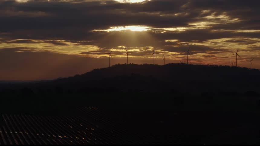The mountain and field are full of windmills and solar panels