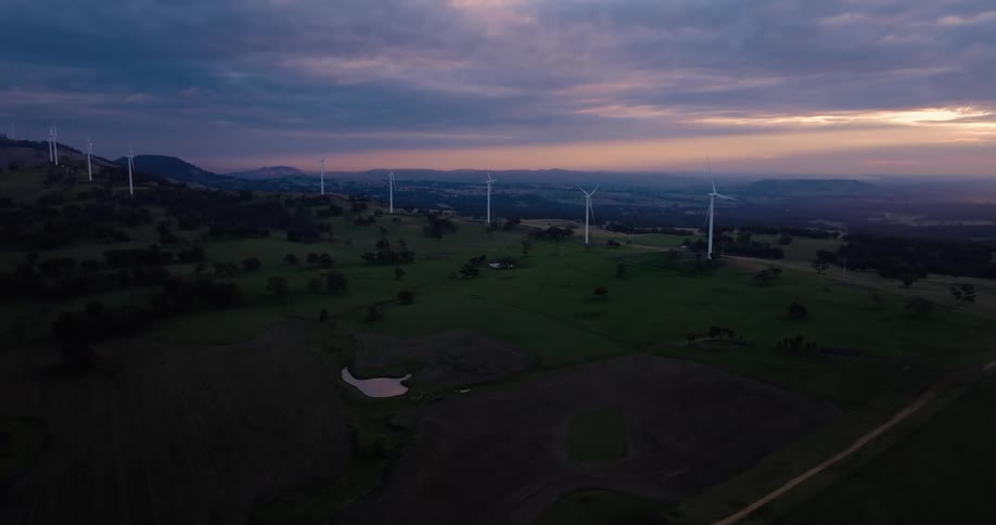 Windmills line a ridge at sunset